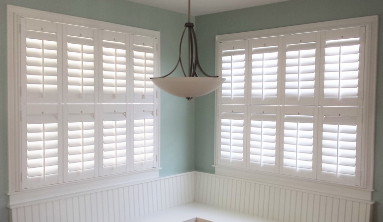 Pastel green wall in Minneapolis kitchen with shutters.